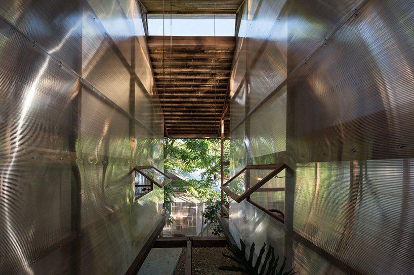 silaa architects connects nature with dorm spaces in vietnamese timber hut