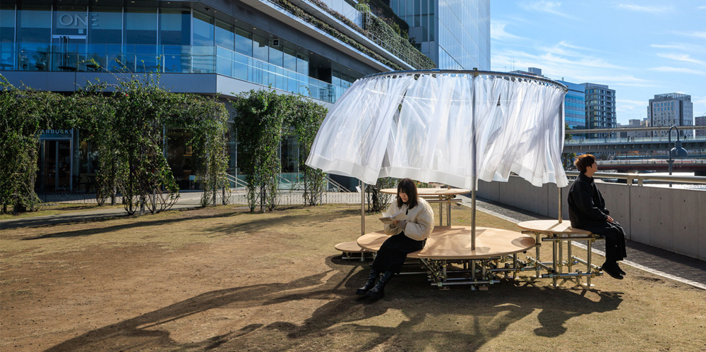 Wind and light flow through organdie curtains of icai architects` street furniture in japan