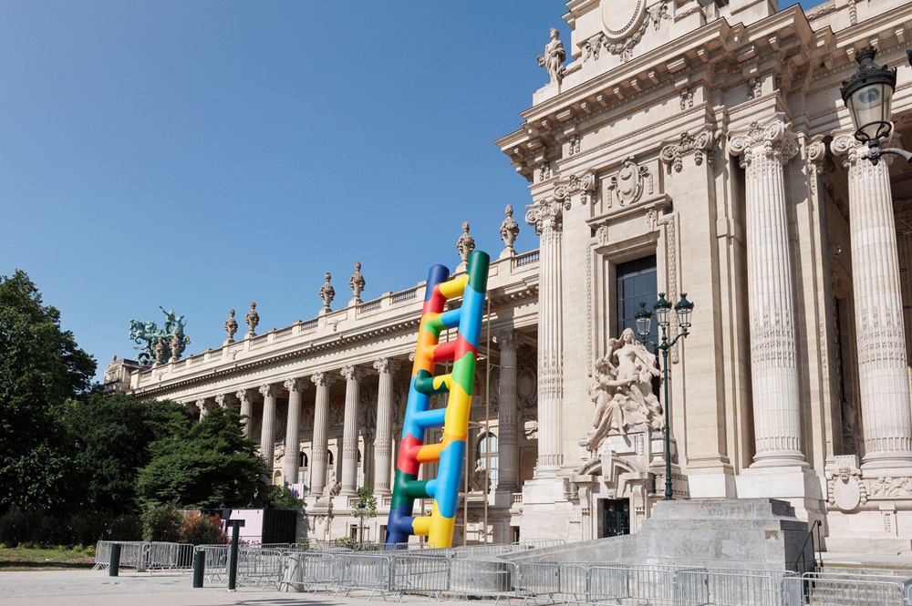 Paola pivi leans 20-meter technicolor ladder against the grand palais in paris