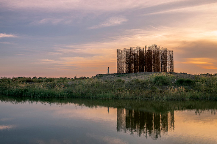 sprawling corten vine installation creates surreal nostalgic scene in chinese wetland